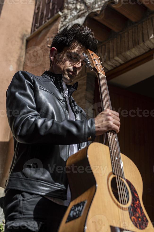 photo of boy holding guitar