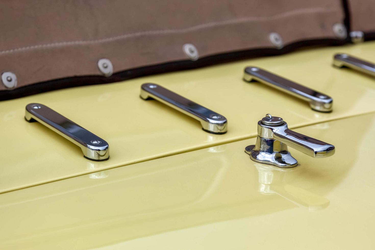 Goodwood, West Sussex, UK, 2012. Close-up Boot Handle on Vintage Yellow Rolls Royce photo