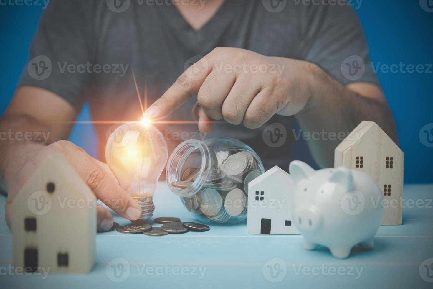 House trading concept. Housing, bank loans to buy a house, real estate investment, real estate business. Man touching a light bulb show ideas for saving money to buy and invest in business property. photo