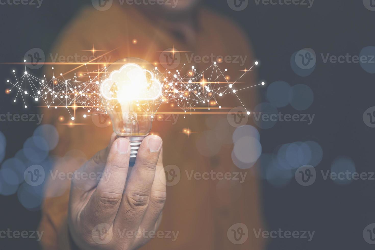 Businessman holding light bulb with cloud computing on hands. Security database and digital networking, Technology of business to the future. Protection cyberspace for uploading and downloading. photo