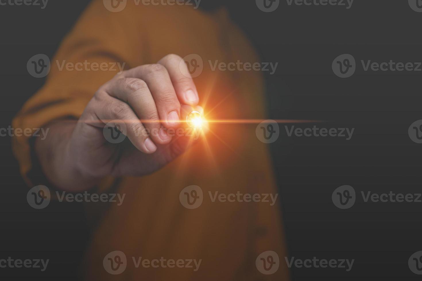 Businessman uses a pen pointing at the virtual screen with copy space. Innovation technology internet business concept. A man pointing at a futuristic interface. photo