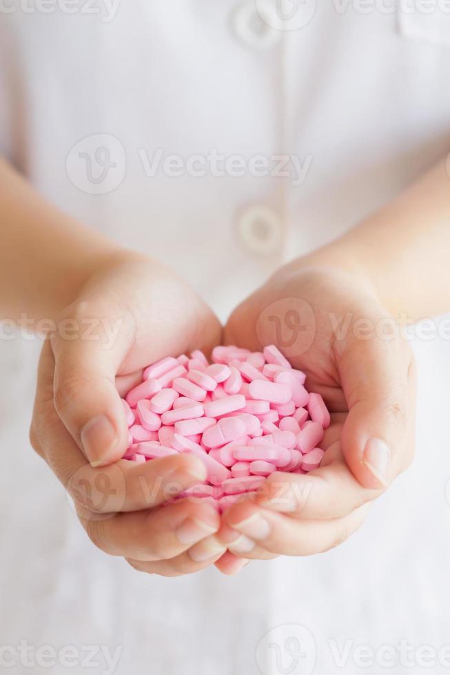 many medicine pills in doctor hands photo