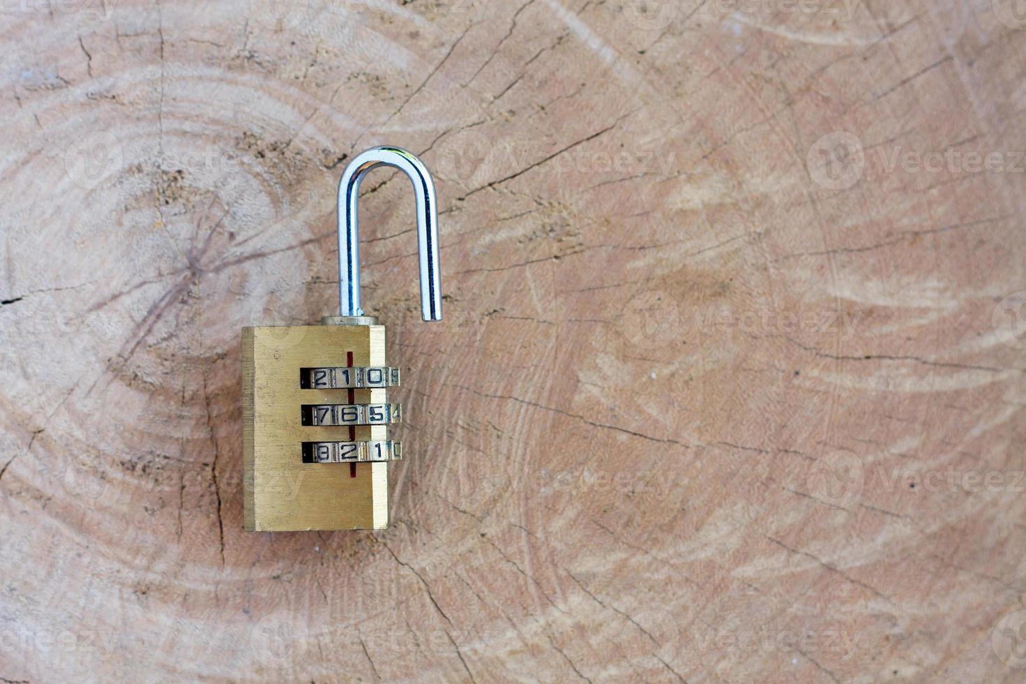 Close up pad lock on wooden background photo