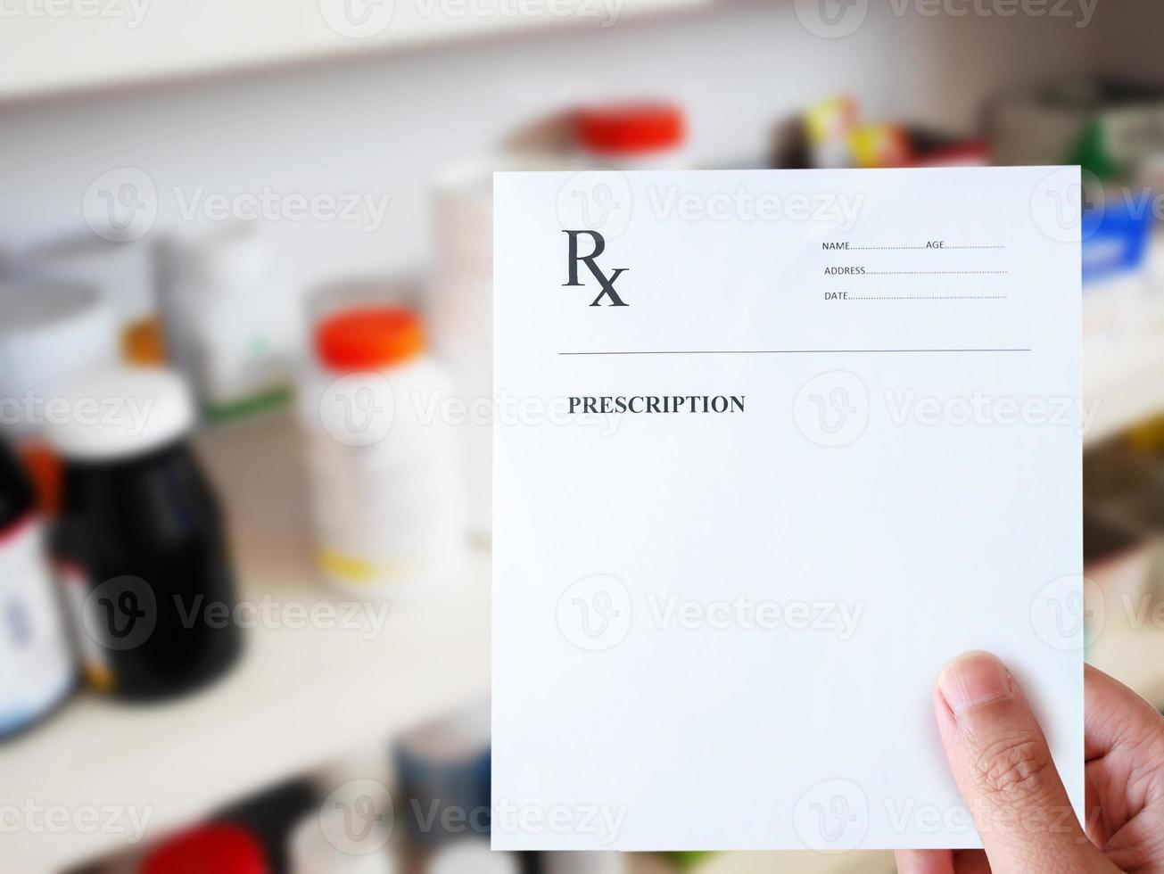 pharmacist hand with prescription paper in the pharmacy photo