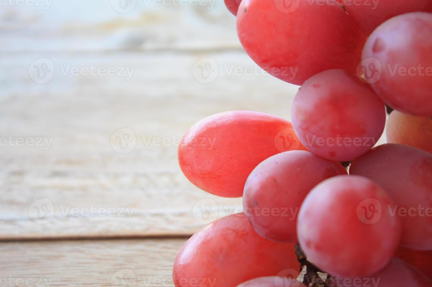 red grapes on wooden background photo
