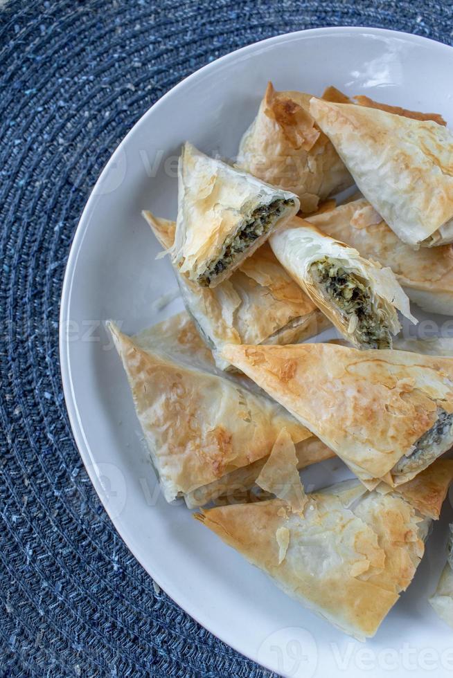 Spanakopita Greek Spinach puff pastry pie triangles 7307801 Stock Photo at Vecteezy