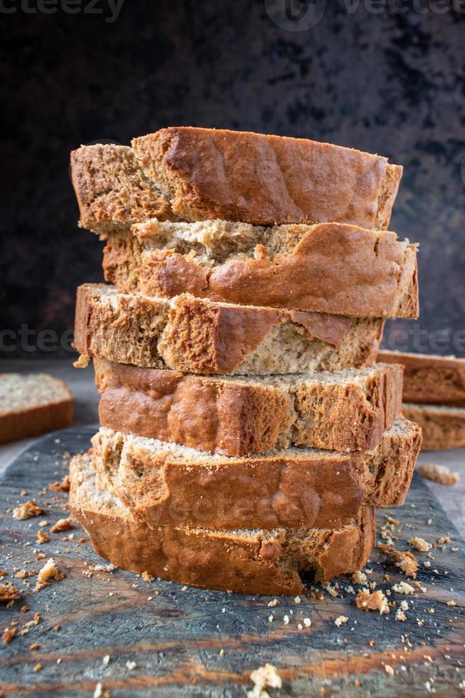 homemade stacked slices of banana bread loaf in rustic setting photo