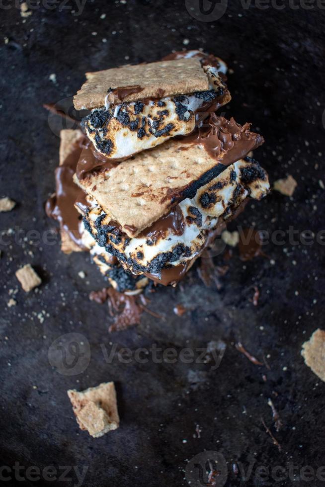 melted messy s'mores stack with toasted marshmallows photo