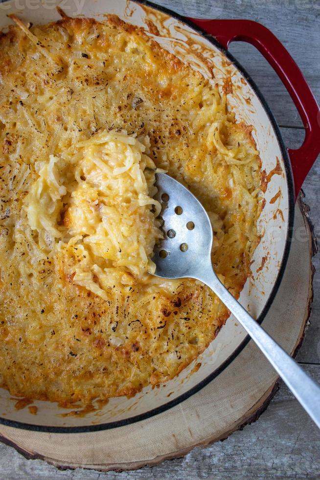 Cheesy tomato pasta shells in cast iron dish flat lay photo