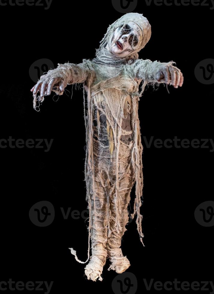 studio shot portrait of young boy in costume dressed as a Halloween, cosplay of scary mummy pose on isolated black background photo