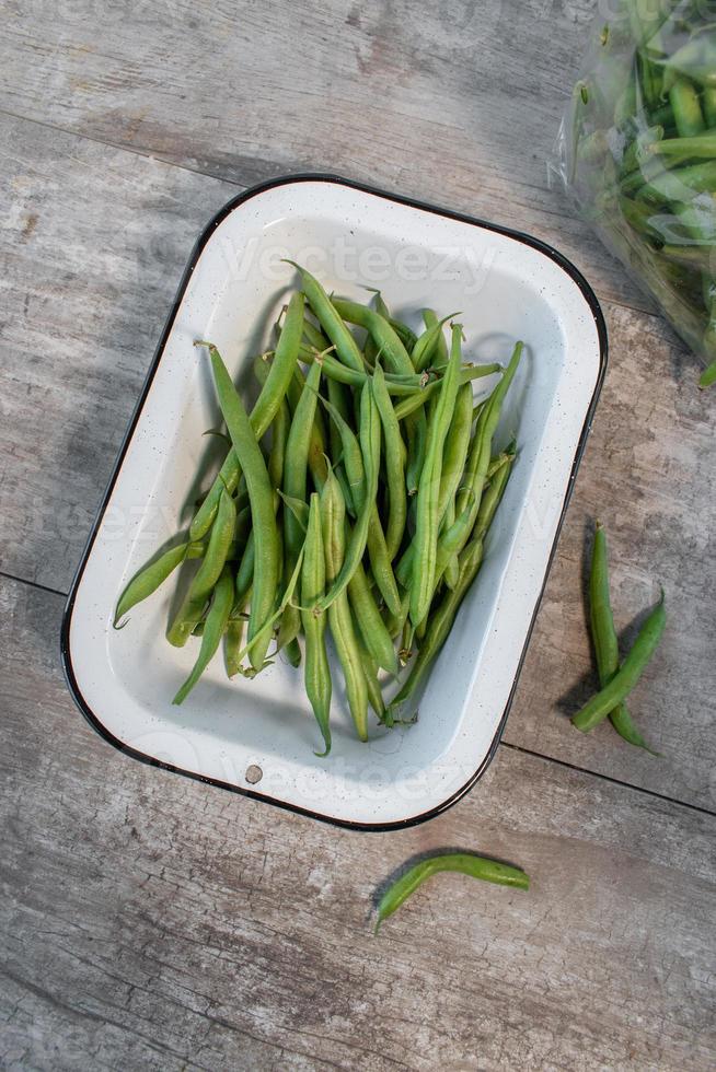 bunch of whole garden green beans in enamel pan flat lay photo