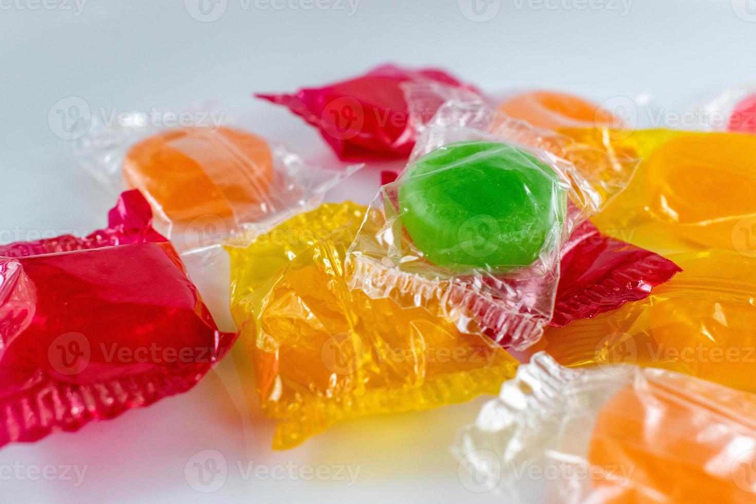 assorted hard candy in wrappers in pile with copy space photo