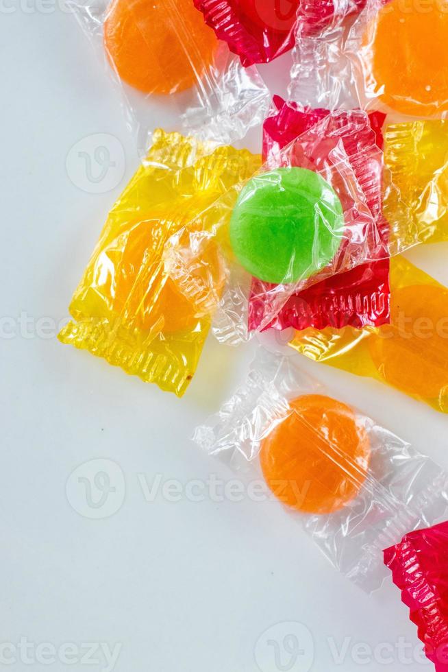 assorted hard candy in wrappers flat lay with copy space photo