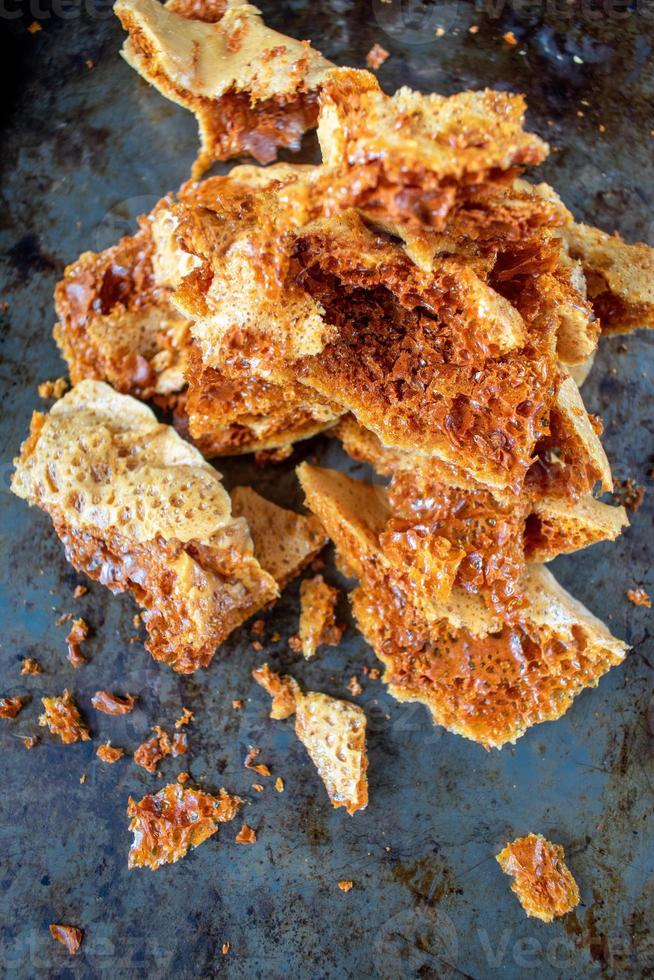 golden homemade honeycomb candy broken into pieces photo