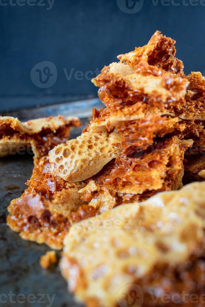 golden homemade honeycomb candy broken into pieces photo