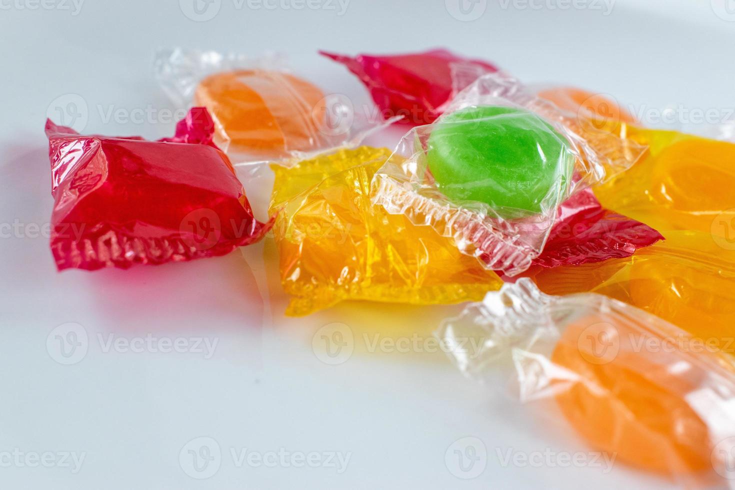 assorted hard candy in wrappers in pile with copy space photo