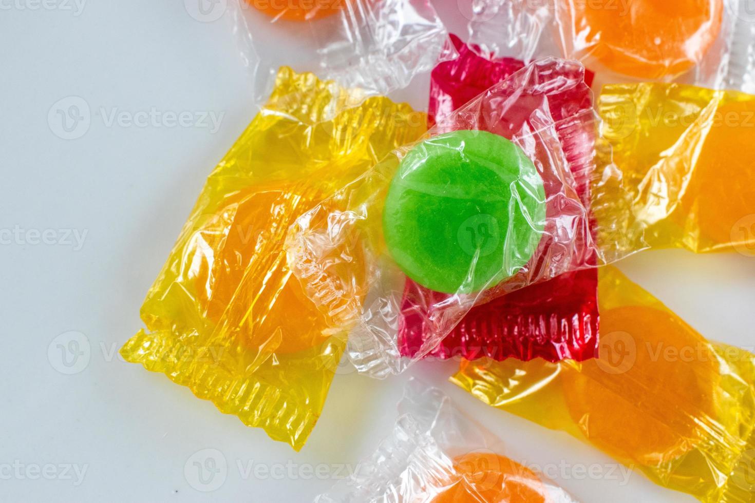 assorted hard candy in wrappers flat lay with copy space photo