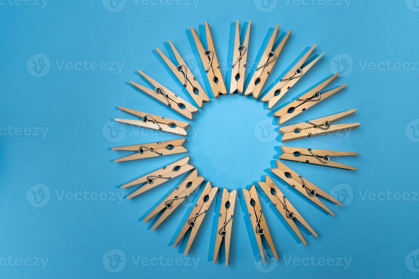 clothespins on vibrant blue in circle pattern photo