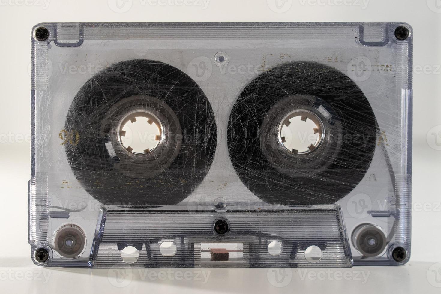 standing clear old retro cassette tape with tape wound half way photo