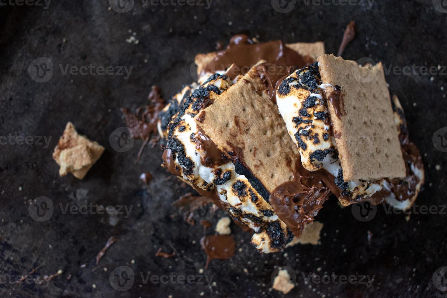 melted messy s'mores stack with toasted marshmallows photo