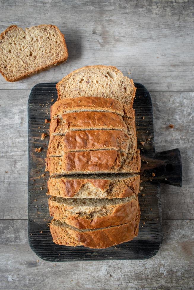homemade stacked slices of banana bread loaf in rustic setting photo