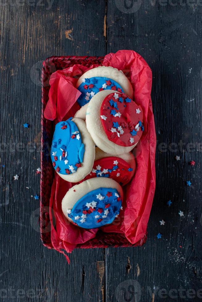 Festive Fourth of July cookies with star sprinkles on wooden table photo