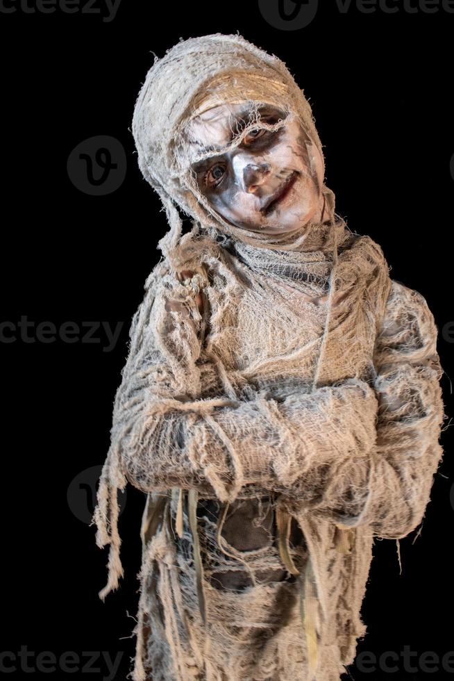 studio shot portrait of young boy in costume dressed as a Halloween, cosplay of scary mummy pose on isolated black background photo