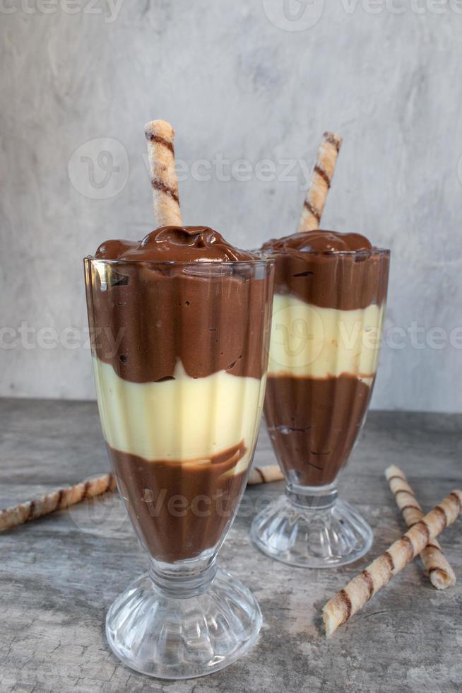 chocolate and vanilla pudding parfait with stripped cookie straw dessert side view photo