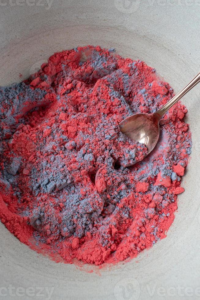 red and purple powdered cake mix in bowl flat lay photo