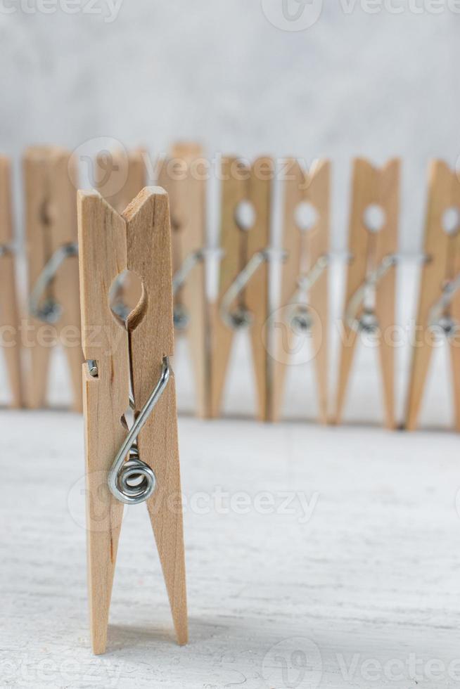 clothespins as concept people in a group with singled out figure photo