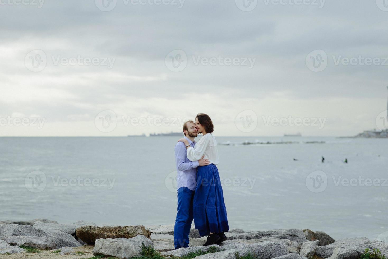 A loving couple, man and woman enjoying summer vacation on a tropical paradise beach with clear sea ocean water and scenic photo