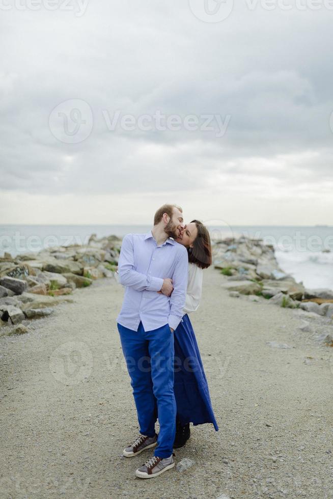 A loving couple, man and woman enjoying summer vacation on a tropical paradise beach with clear sea ocean water and scenic photo