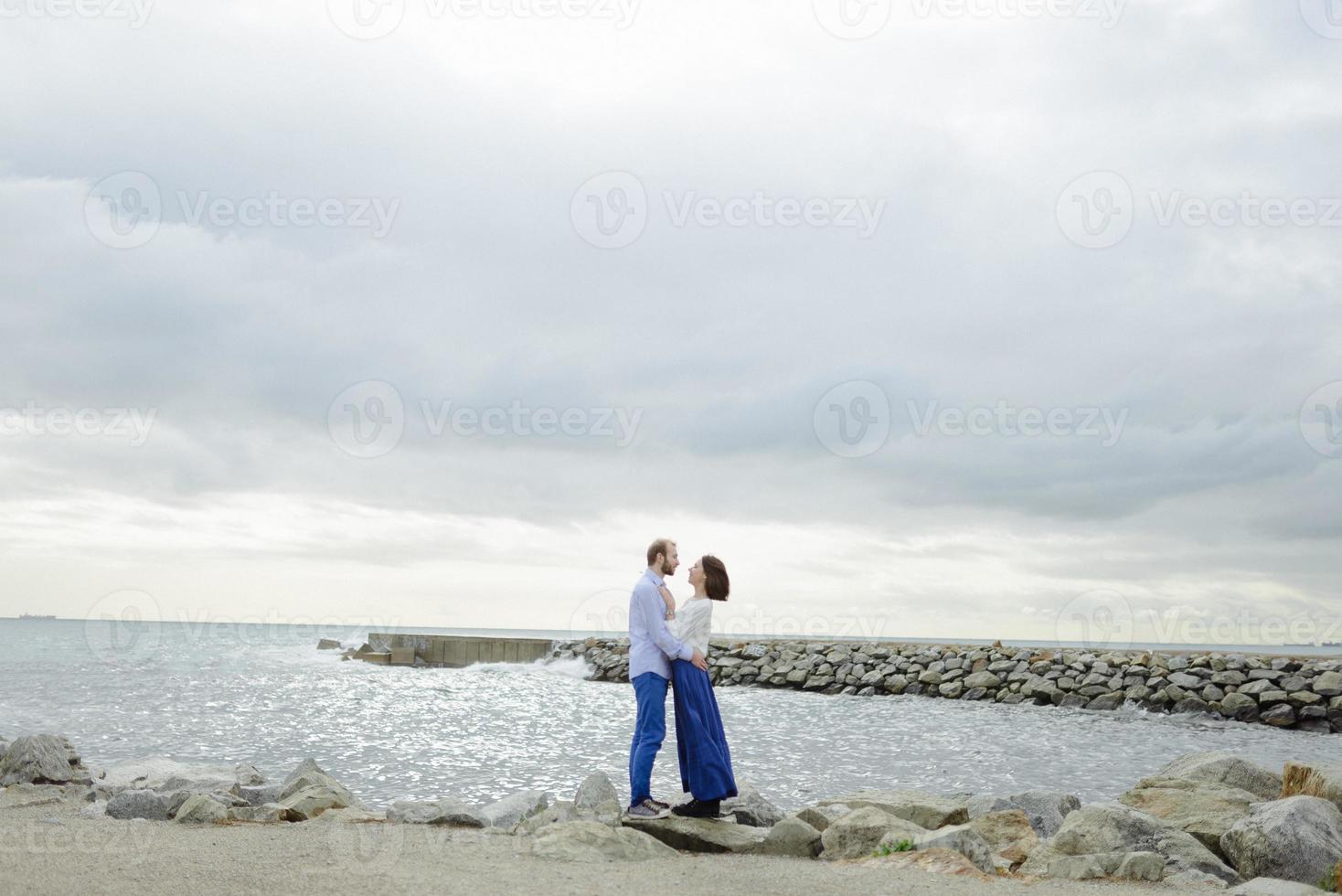 A loving couple, man and woman enjoying summer vacation on a tropical paradise beach with clear sea ocean water and scenic photo