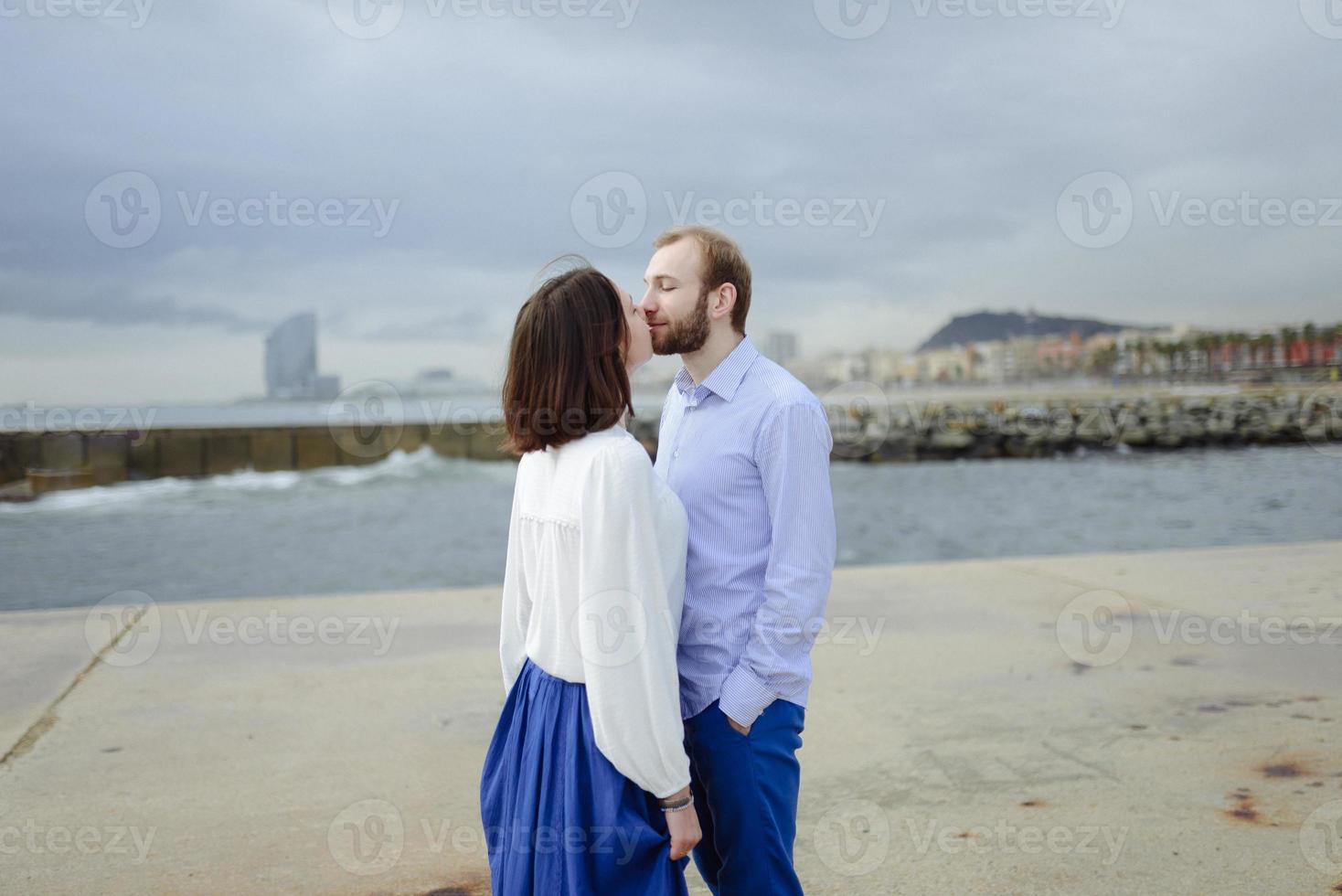 A loving couple, man and woman enjoying summer vacation on a tropical paradise beach with clear sea ocean water and scenic photo