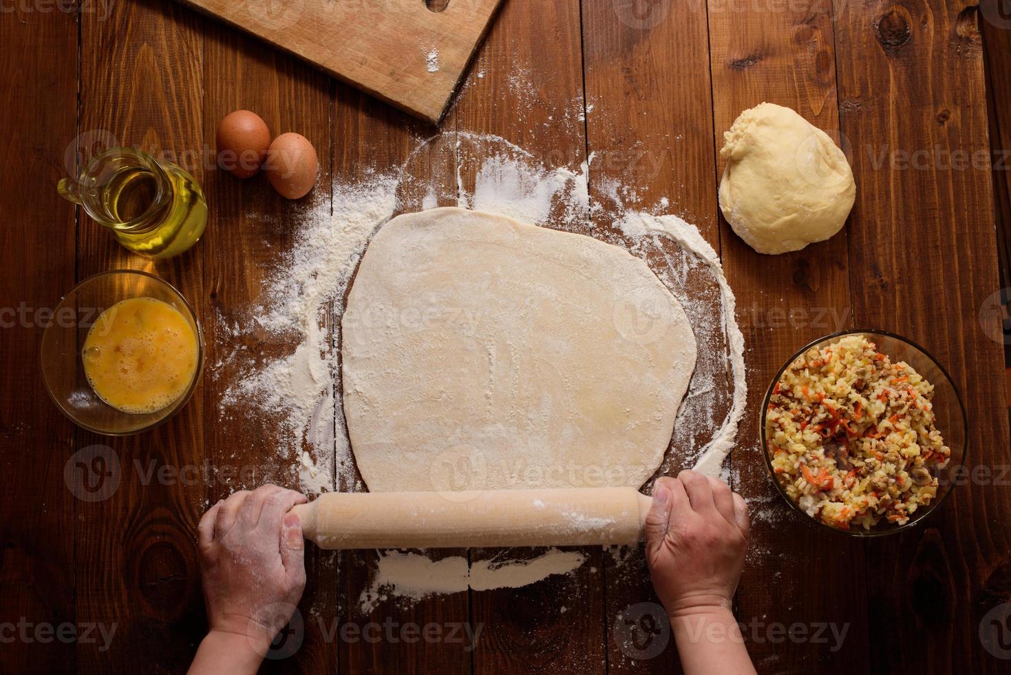 Raw homemade pies on a wooden background. photo