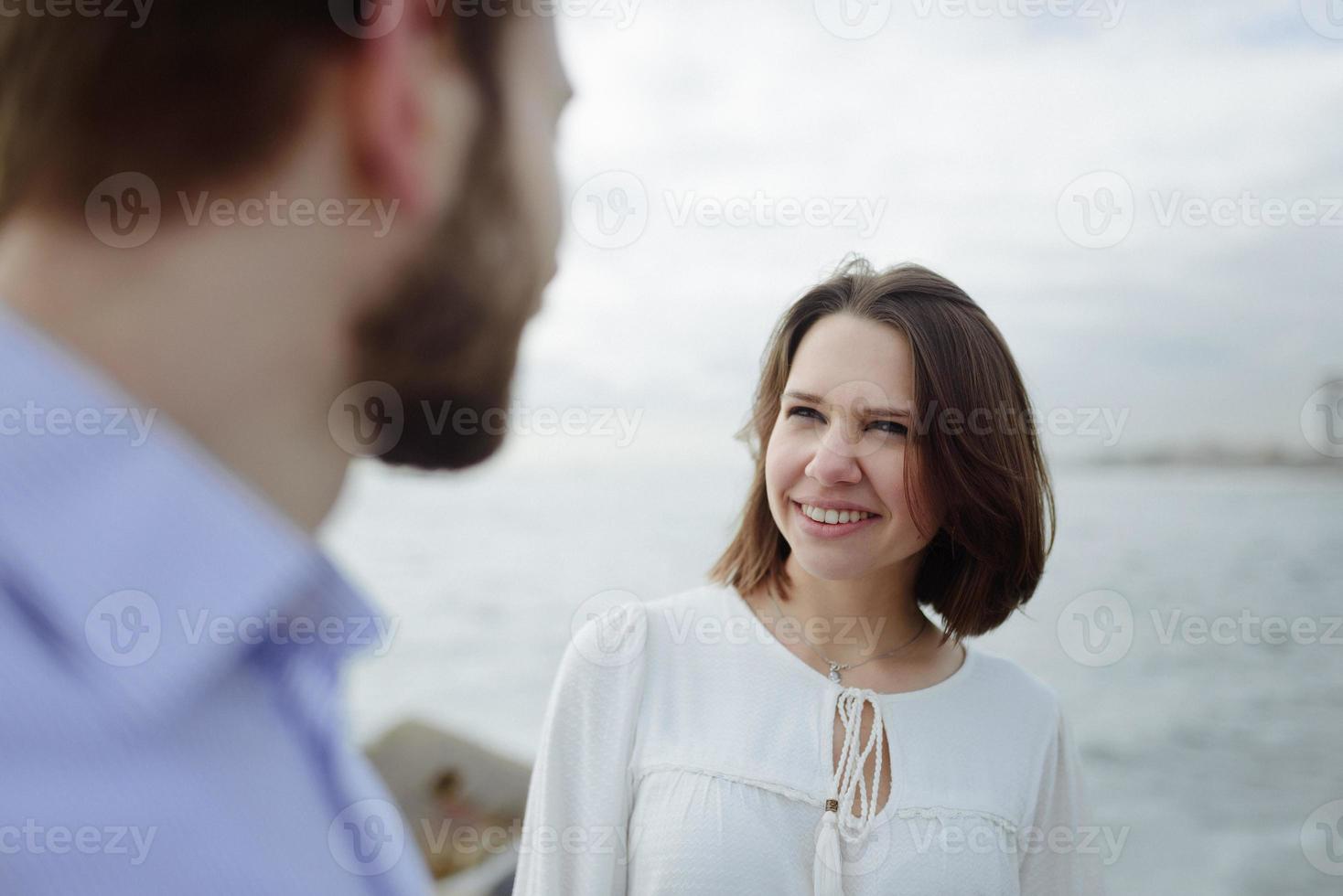 A loving couple, man and woman enjoying summer vacation on a tropical paradise beach with clear sea ocean water and scenic photo