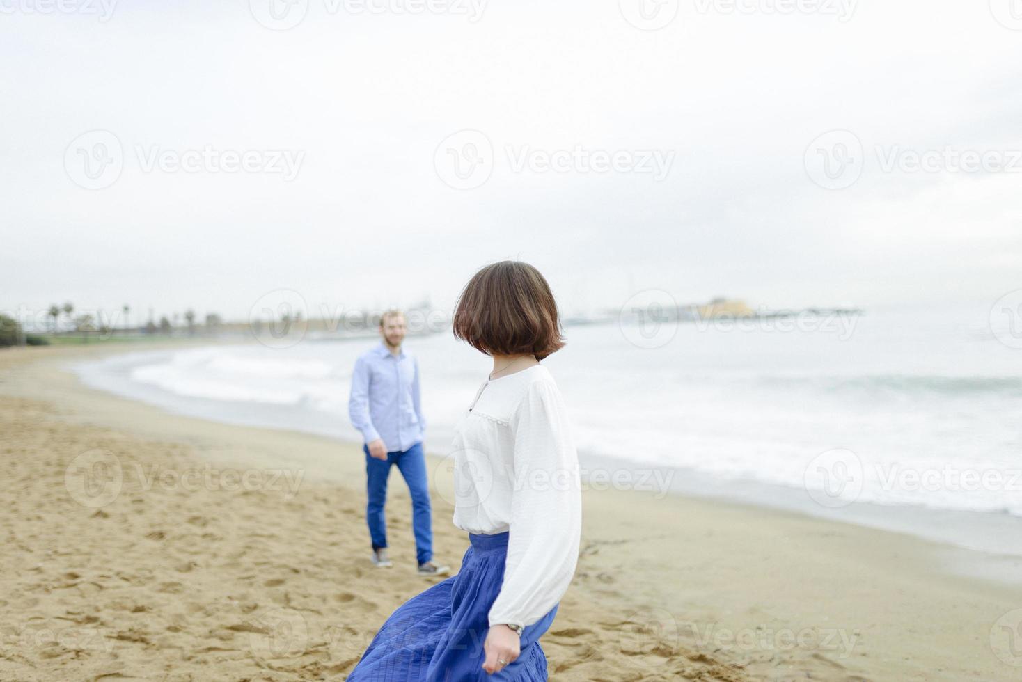 A loving couple, man and woman enjoying summer vacation on a tropical paradise beach with clear sea ocean water and scenic photo