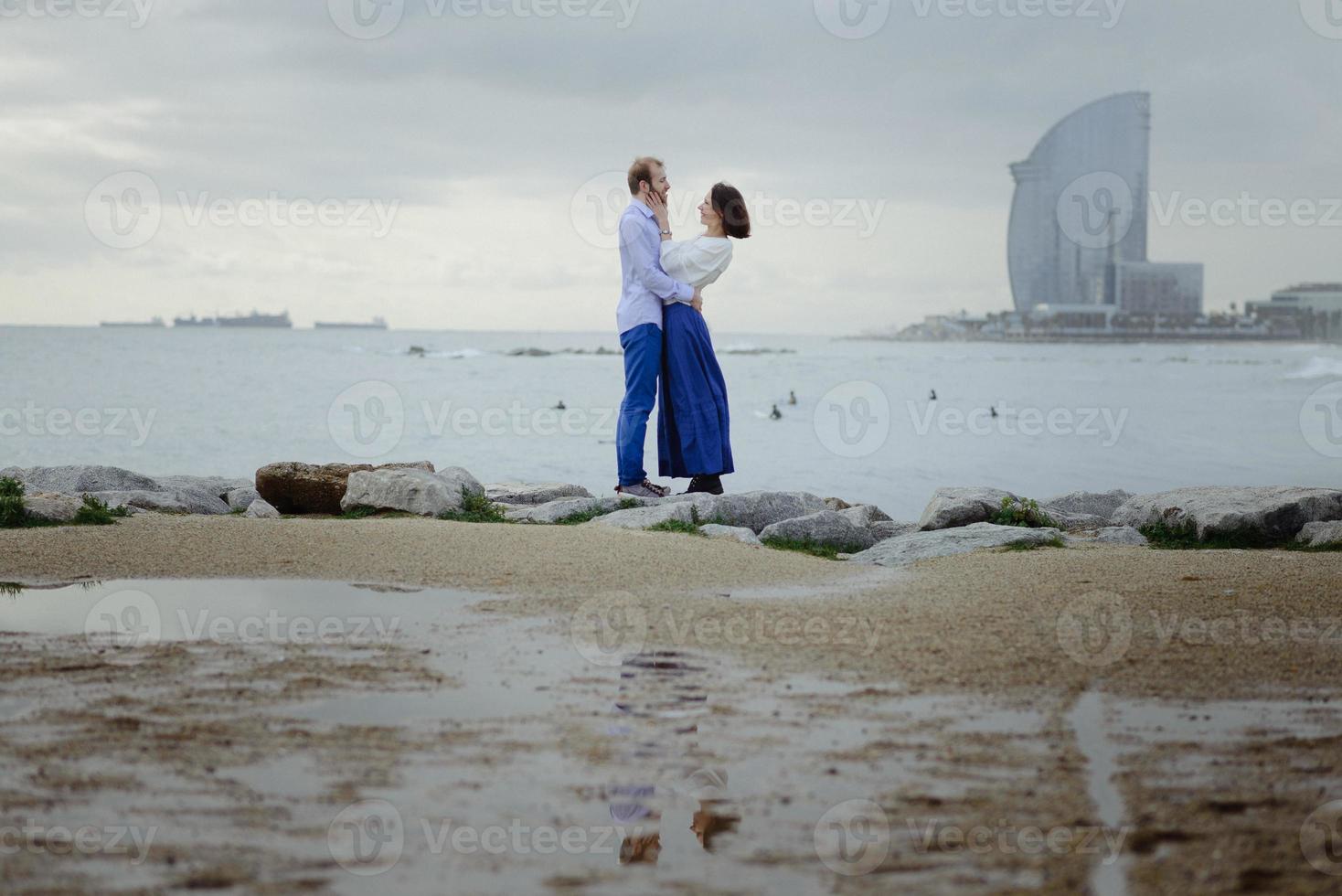 A loving couple, man and woman enjoying summer vacation on a tropical paradise beach with clear sea ocean water and scenic photo