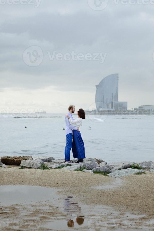 A loving couple, man and woman enjoying summer vacation on a tropical paradise beach with clear sea ocean water and scenic photo