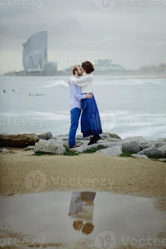 A loving couple, man and woman enjoying summer vacation on a tropical paradise beach with clear sea ocean water and scenic photo