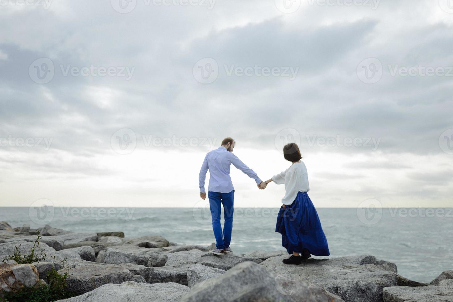 A loving couple, man and woman enjoying summer vacation on a tropical paradise beach with clear sea ocean water and scenic photo