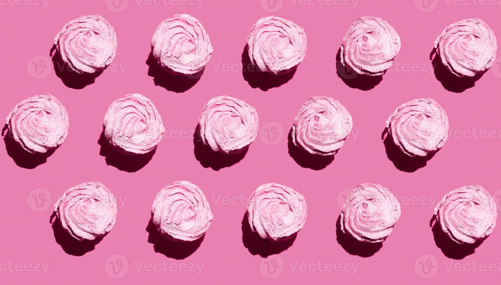 marshmallow in pink colors on pink background with copy space photo