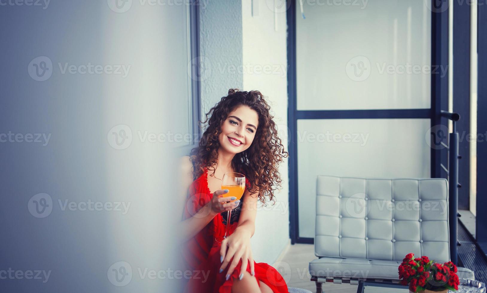 woman in red dress tasting fresh juice photo