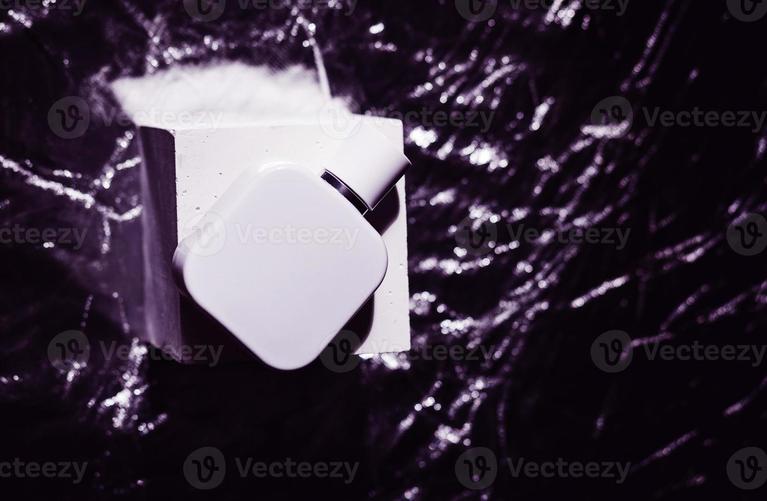 Perfume bottle on cube photo