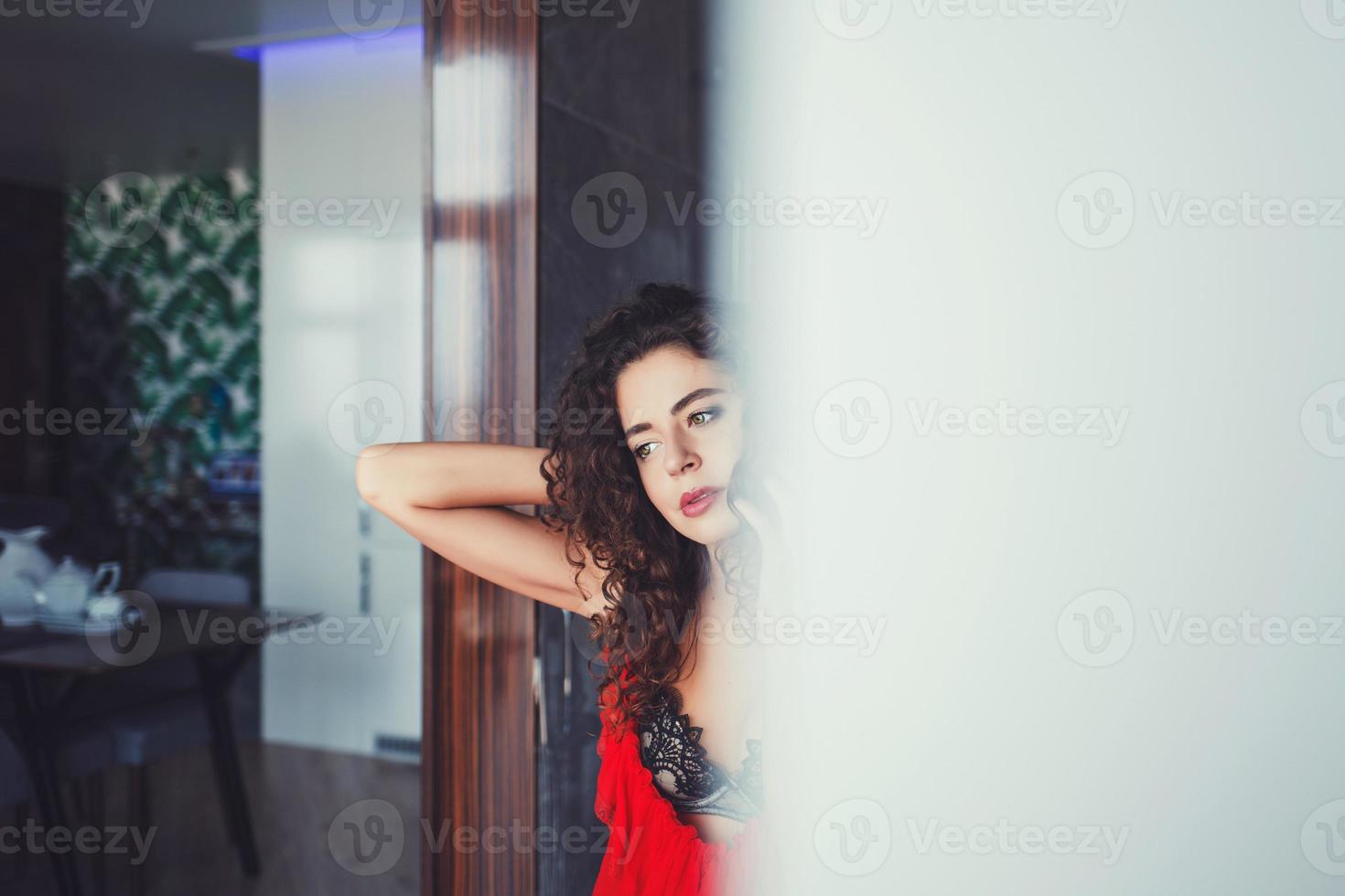 woman with curly hair in red dress photo