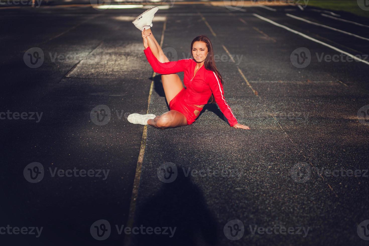 Fit woman stretching her leg photo