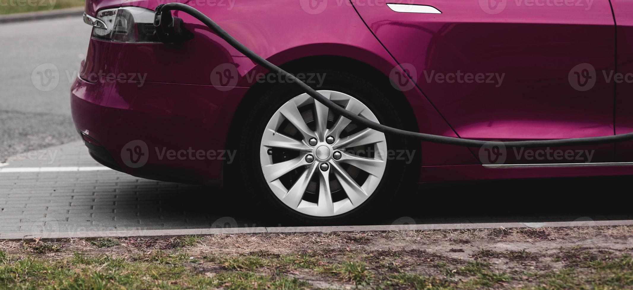 Electric car charging on parking lot photo