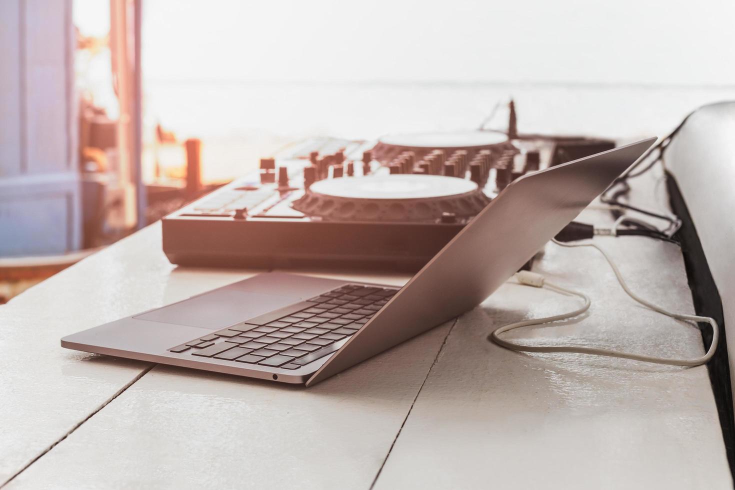 DJ sound control table mixing and laptop computer on table outdoors. photo