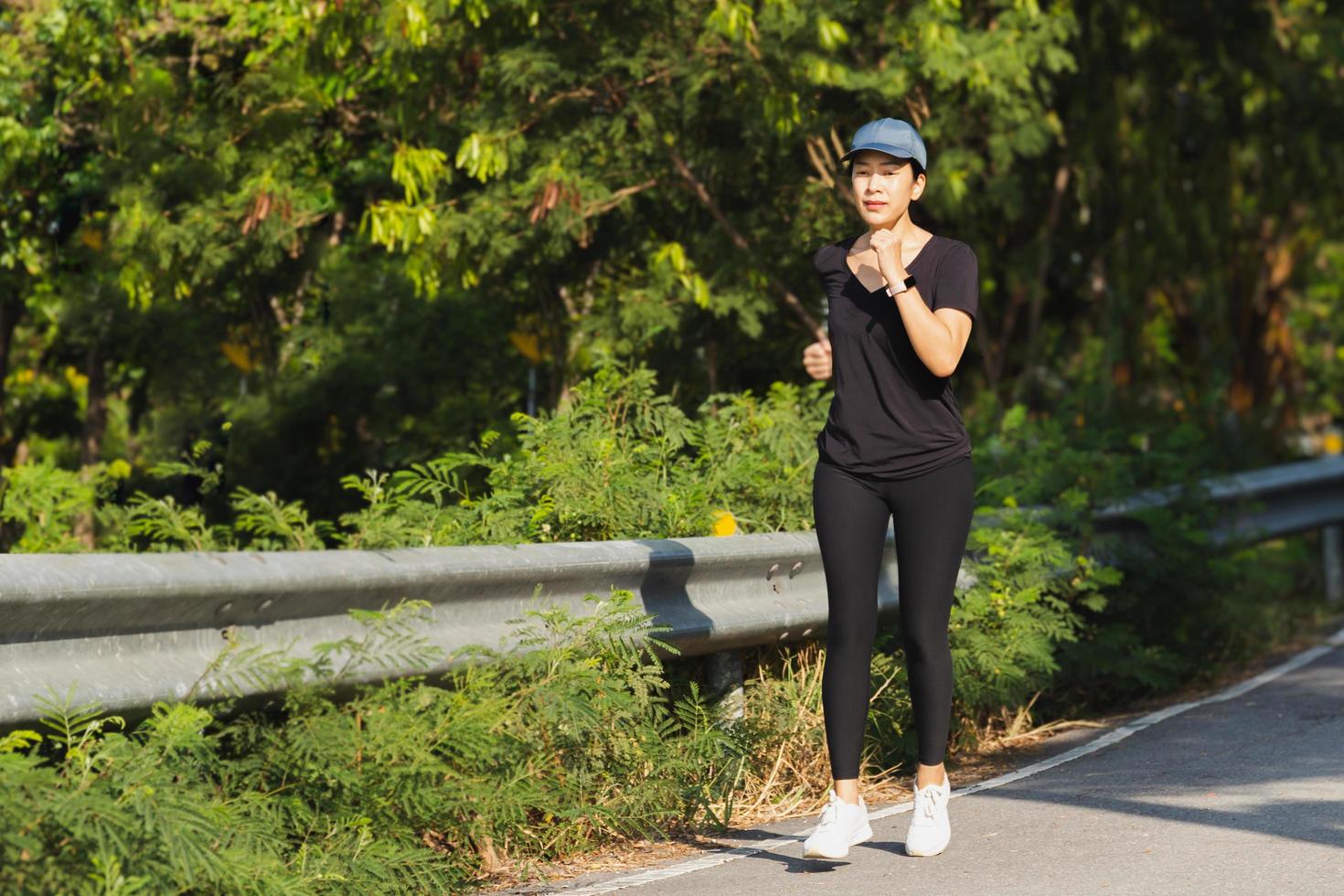 Woman exercise running on the road in the park. photo