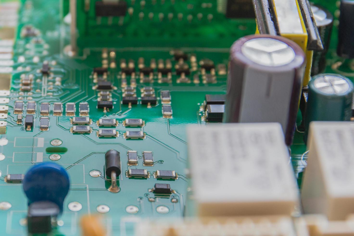 Macro Integrated semiconductor microchip on green circuit board. photo